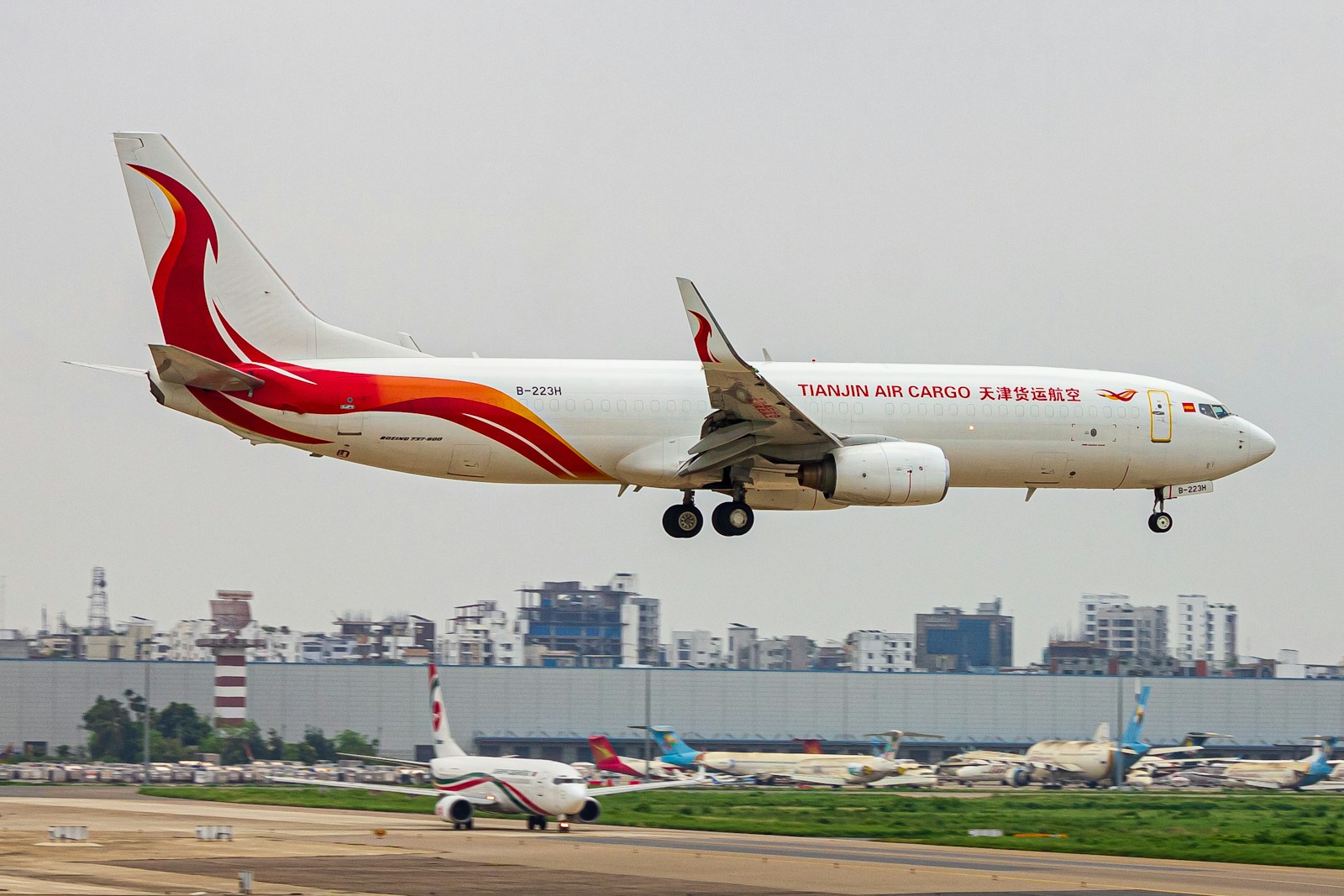 A large jetliner flying through a cloudy sky